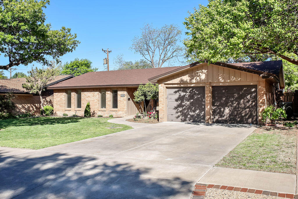 4106 64th Street Lubbock, TX 79413 - Photo 3 of 60 a front view of a house with garden