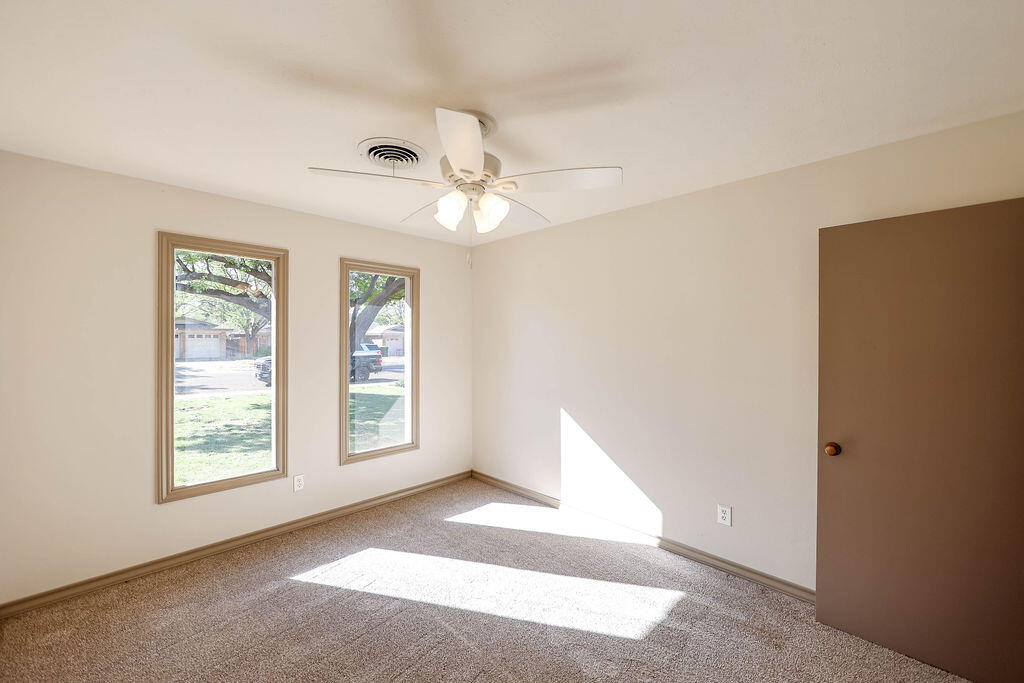 4106 64th Street Lubbock, TX 79413 - Photo 33 of 60 a view of an empty room with windows