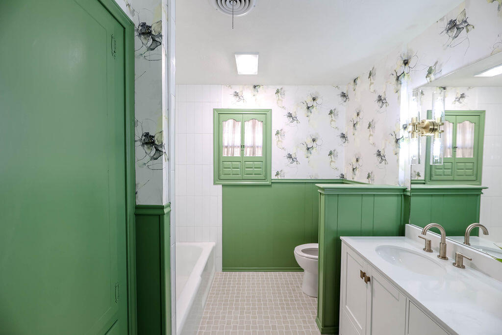 4106 64th Street Lubbock, TX 79413 - Photo 36 of 60 a bathroom with a sink a green toilet and a bathtub