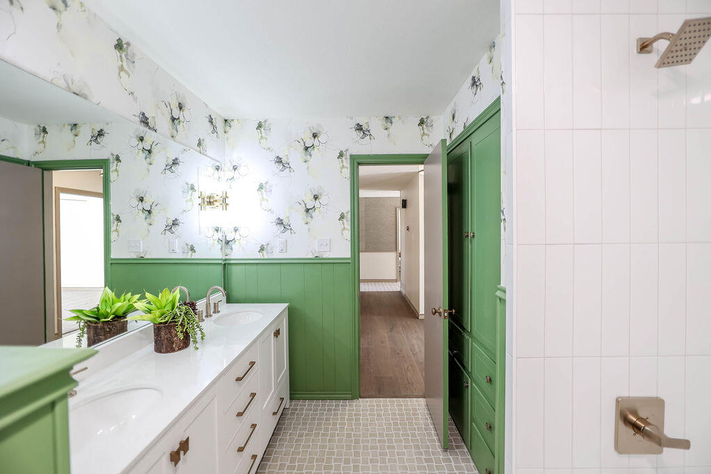 4106 64th Street Lubbock, TX 79413 - Photo 38 of 60 a bathroom with a sink a mirror and a shower