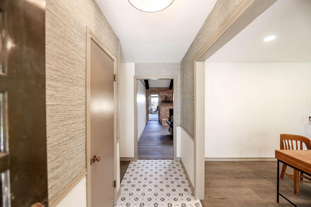 4106 64th Street Lubbock, TX 79413 - Photo 4 of 60 a view of a hallway with wooden floor and a living room