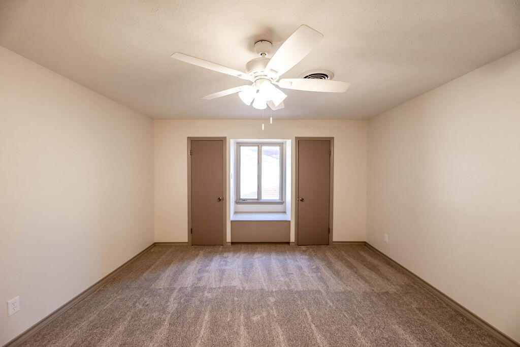 4106 64th Street Lubbock, TX 79413 - Photo 41 of 60 a view of empty room with wooden floor and fan