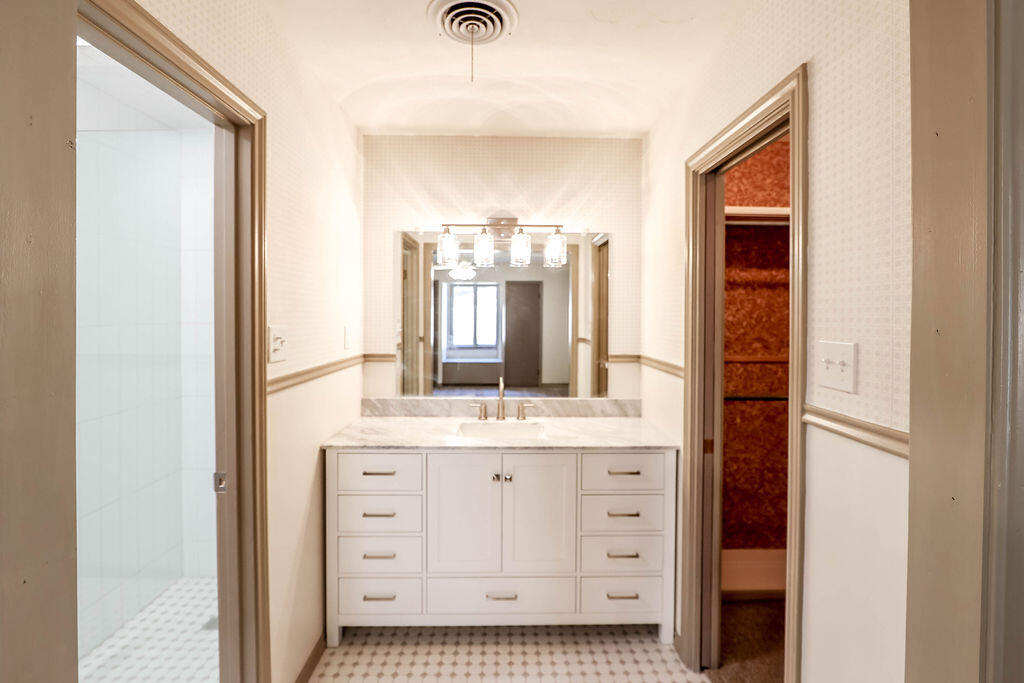 4106 64th Street Lubbock, TX 79413 - Photo 43 of 60 a bathroom with a double vanity sink and mirror