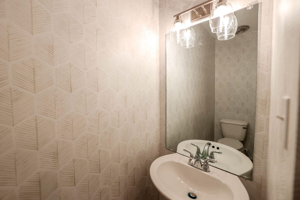 4106 64th Street Lubbock, TX 79413 - Photo 57 of 60 a bathroom with a sink and mirror