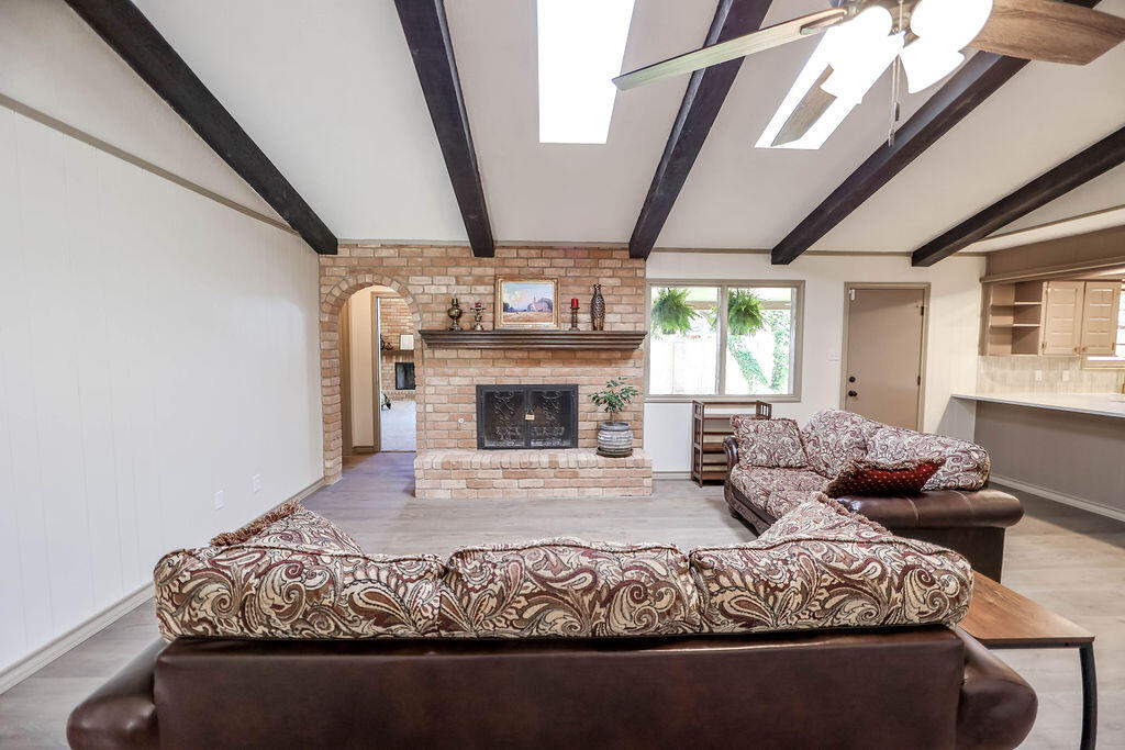 4106 64th Street Lubbock, TX 79413 - Photo 8 of 60 a living room with furniture large window and fireplace