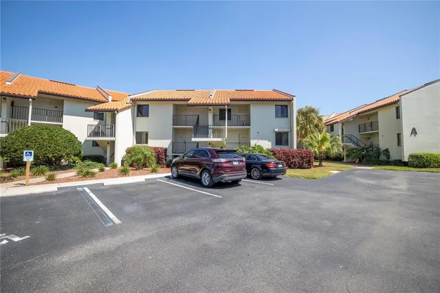 a couple of cars parked in front of a house