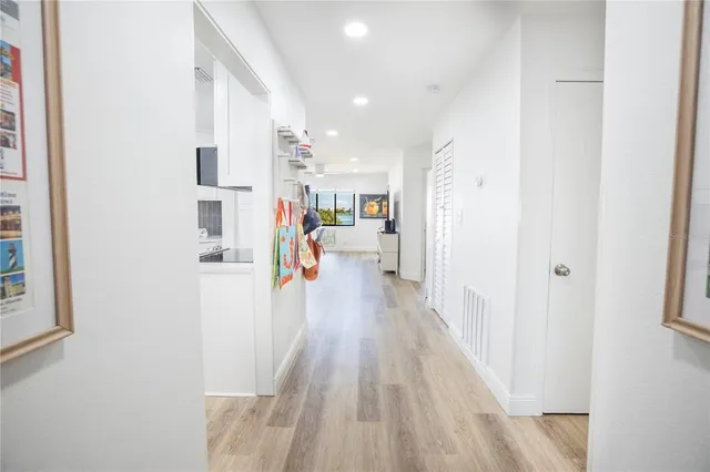 a view of a living room with furniture and wooden floor