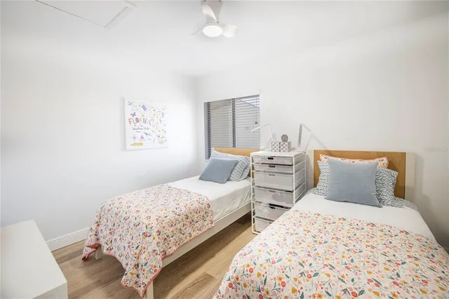 a bedroom with two beds and a lamp