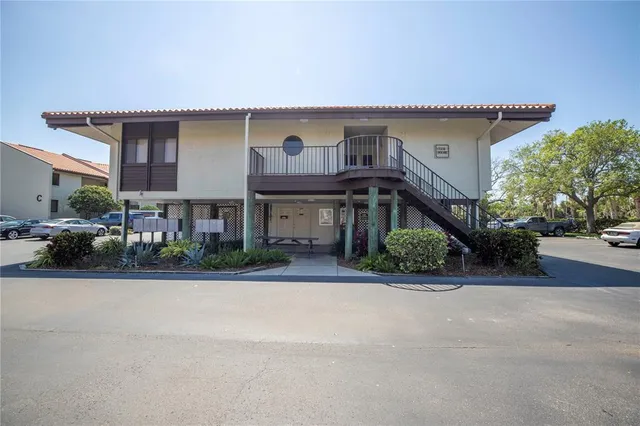 a front view of a house with a yard and potted plants