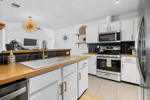 a stove top oven sitting inside of a kitchen
