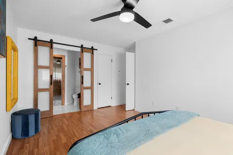 a living room with a bed furniture and a window