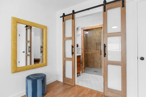 a bedroom with a bed and wooden floor