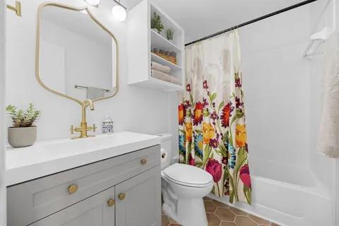 a bedroom with bed and chair