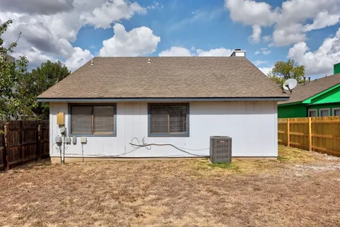 a bedroom with beds and window