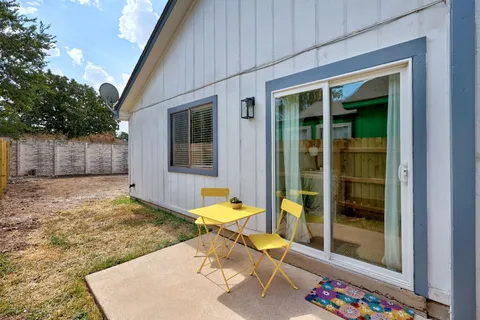 a backyard of a house with lots of green space and chandelier