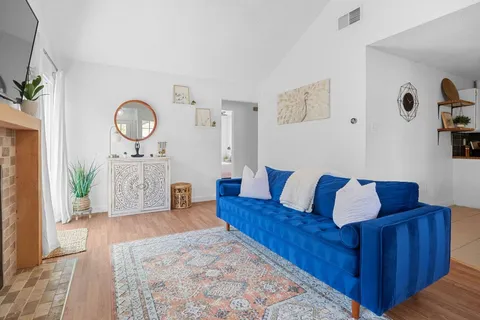 a living room with couch and paintings on the wall