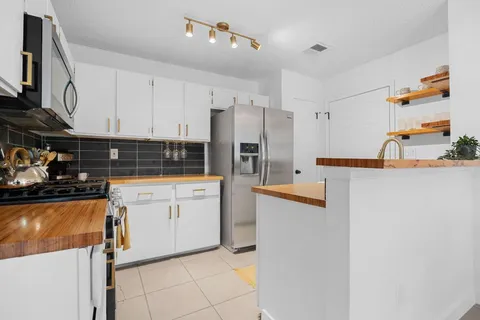 a living room with fireplace furniture and a flat screen tv