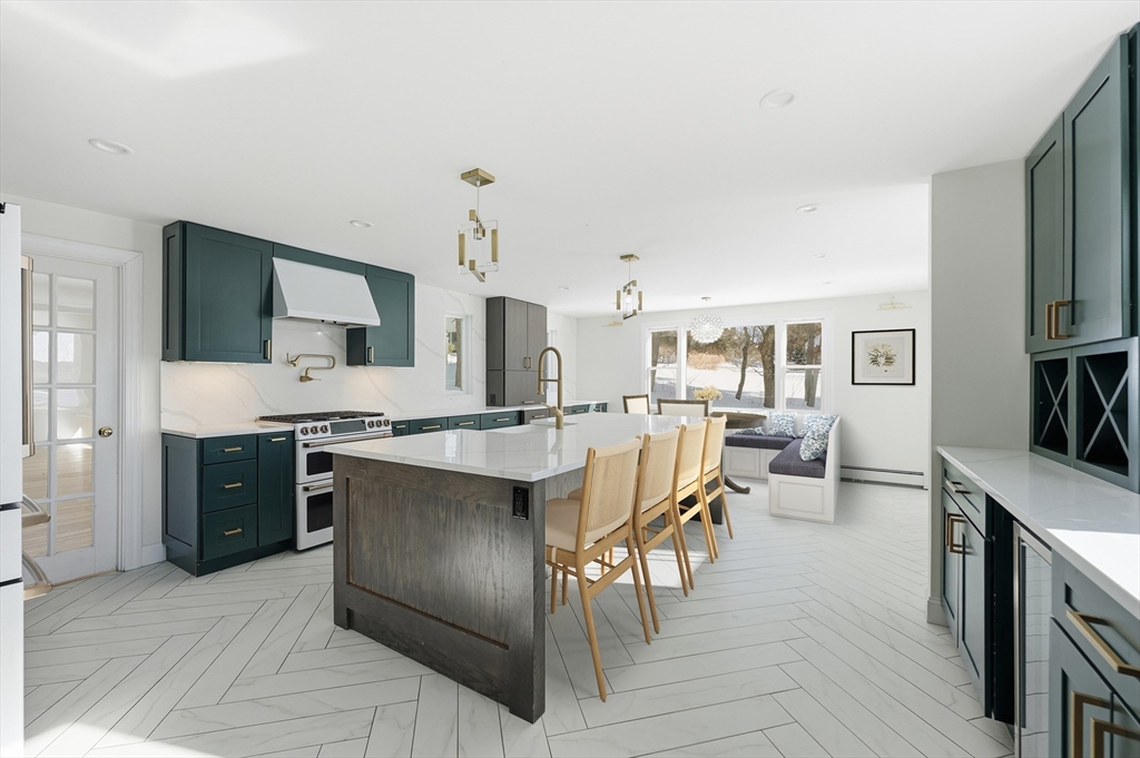 124 Everett Street Natick, MA 01760 - Photo 12 of 26 a large kitchen with a table and chairs in it