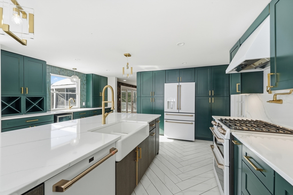 124 Everett Street Natick, MA 01760 - Photo 13 of 26 a kitchen with kitchen island a sink stove and refrigerator