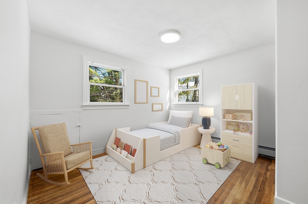 124 Everett Street Natick, MA 01760 - Photo 21 of 26 a bedroom with a bed and wooden floor