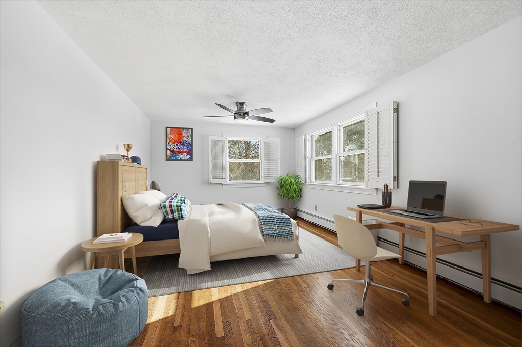 124 Everett Street Natick, MA 01760 - Photo 22 of 26 a bedroom with furniture and a wooden floor