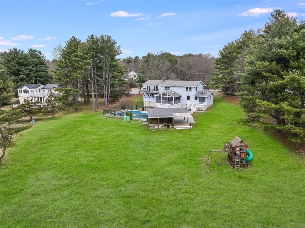 124 Everett Street Natick, MA 01760 - Photo 5 of 26 a green field with lots of trees in front of it