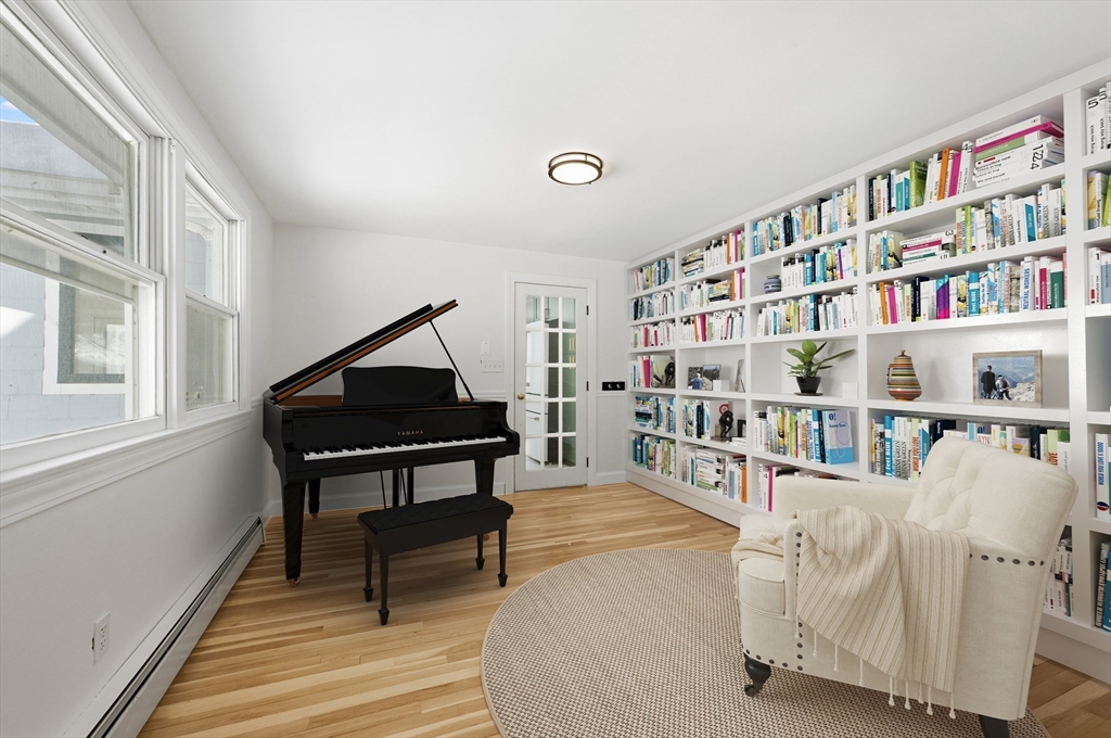 124 Everett Street Natick, MA 01760 - Photo 9 of 26 a living room with lots of furniture and a book shelf