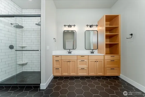 a bathroom with a double vanity sink mirror and