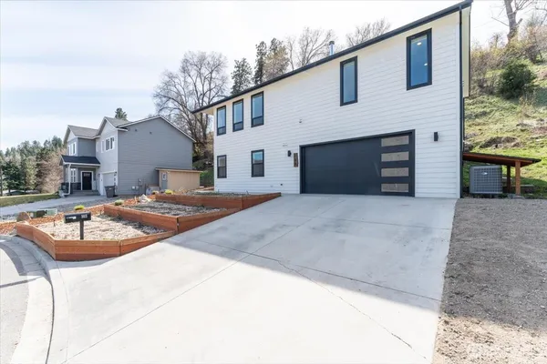 a front view of a house with yard and garage