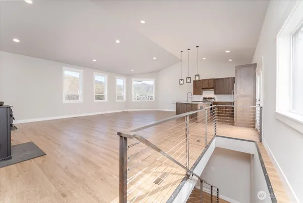 a view of a kitchen with kitchen island a counter top space appliances and cabinets