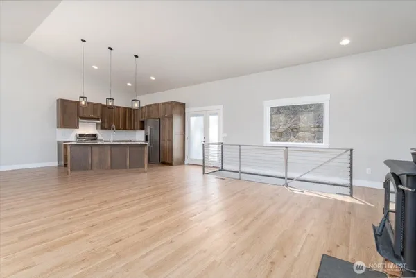 a view of a kitchen with a sink and a refrigerator