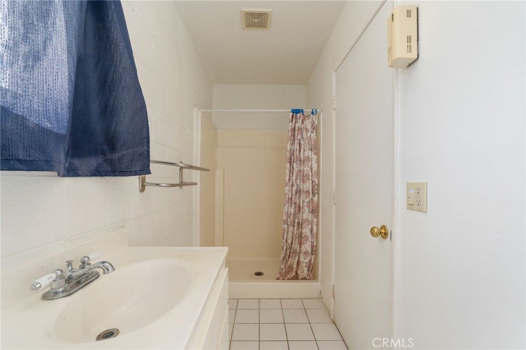 21871 Richard Street Perris, CA 92570 - Photo 15 of 75 a bathroom with a bathtub and shower