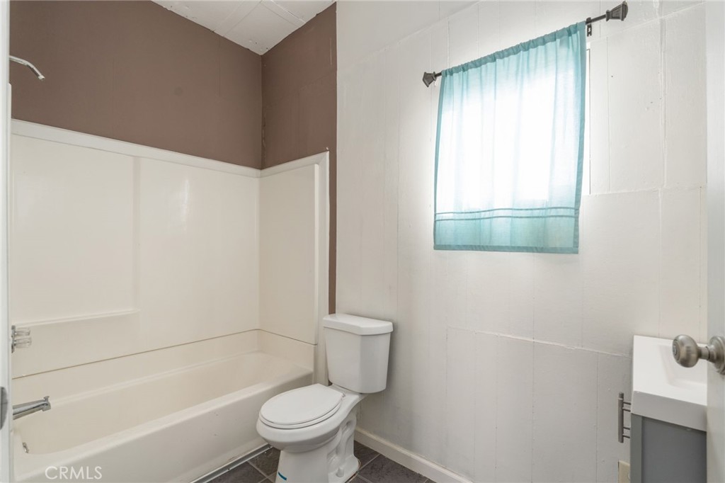 21871 Richard Street Perris, CA 92570 - Photo 25 of 75 a white toilet sitting next to a bath tub