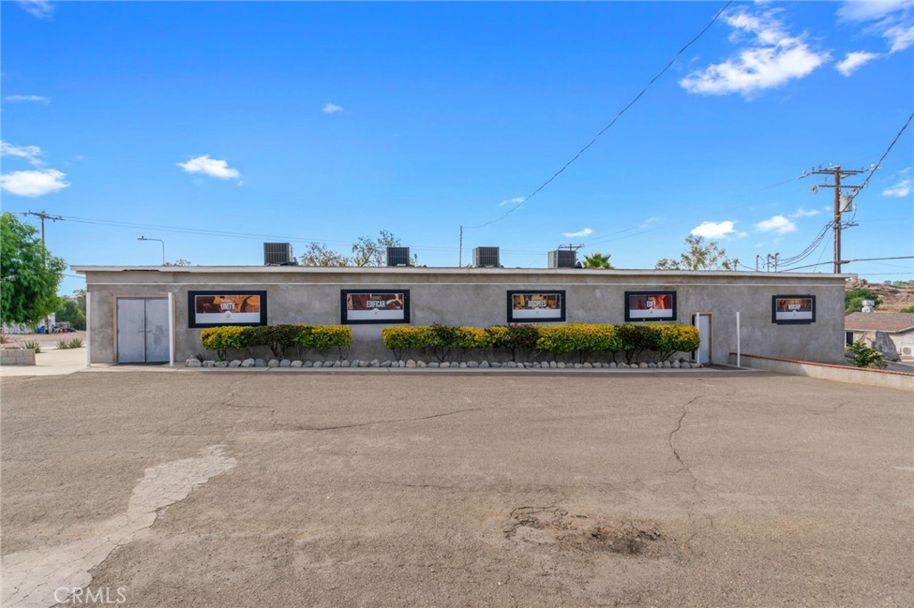 21871 Richard Street Perris, CA 92570 - Photo 26 of 75 a front view of a house with a yard and a garage