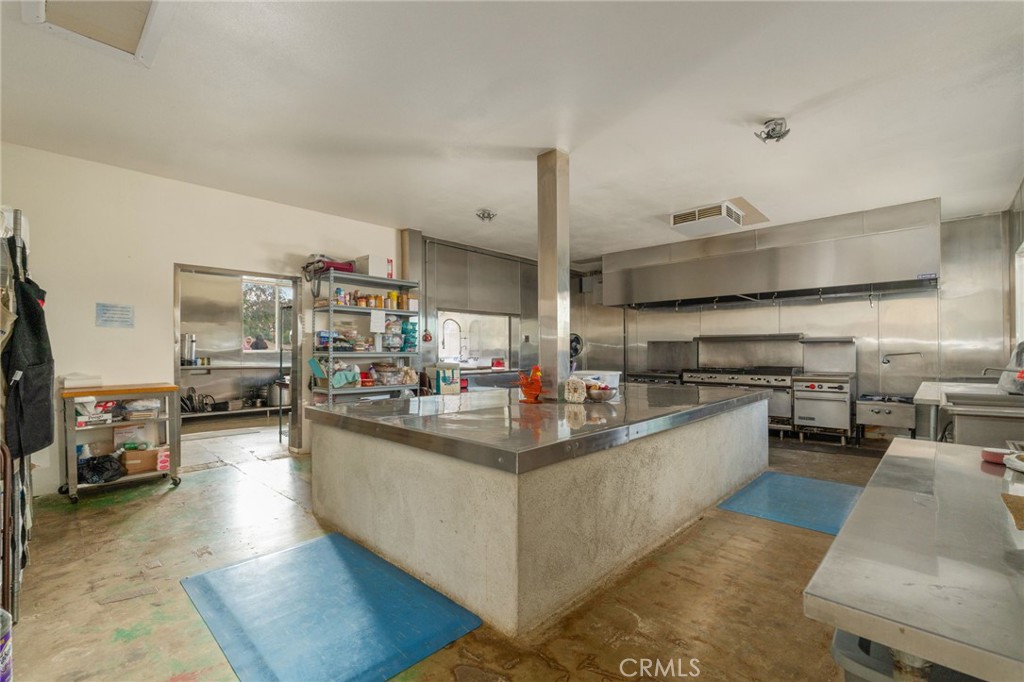 21871 Richard Street Perris, CA 92570 - Photo 49 of 75 a kitchen with counter top space a sink and stainless steel appliances