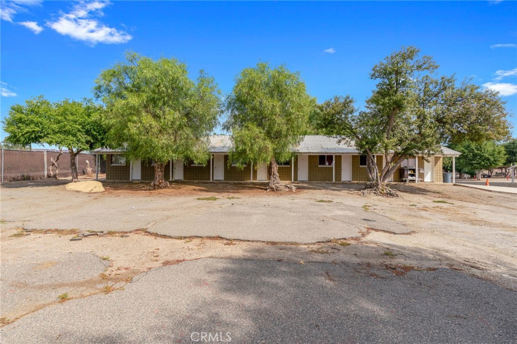 21871 Richard Street Perris, CA 92570 - Photo 64 of 75 a backyard of a house with large trees and outdoor space