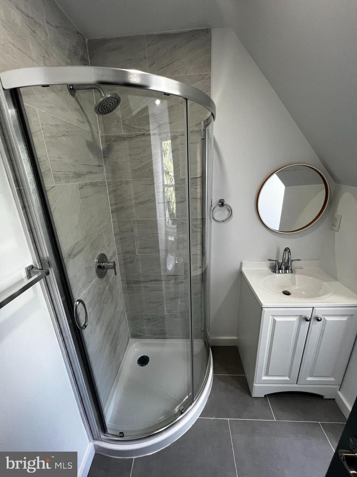 1551 Church Street, Unit 2 Philadelphia, PA 19124 - Photo 8 of 14 a bathroom with a mirror and a shower