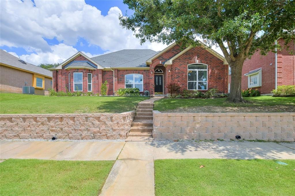 View of front of home featuring brick siding, central AC unit, a front yard, and roof with shingles