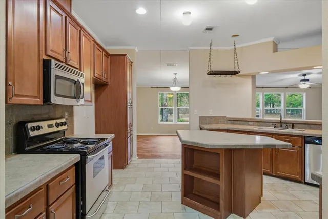 a kitchen with a sink stove and cabinets