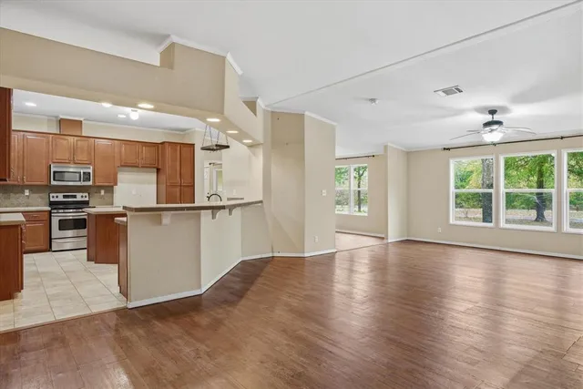 a view of a kitchen with granite countertop cabinets and wooden floor