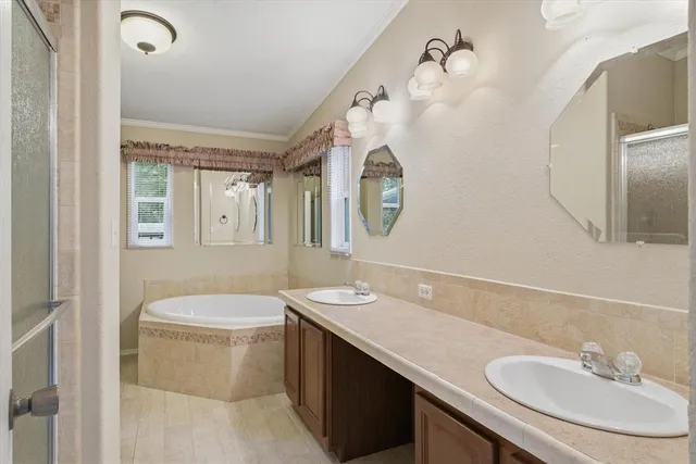 a white bath tub sitting next to a white cabinet