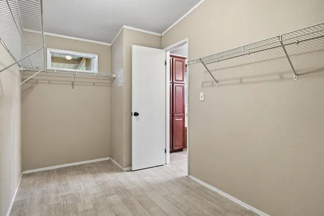 a view of a hallway with wooden floor and door