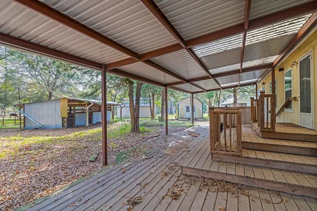 a view of a house with backyard and a tree