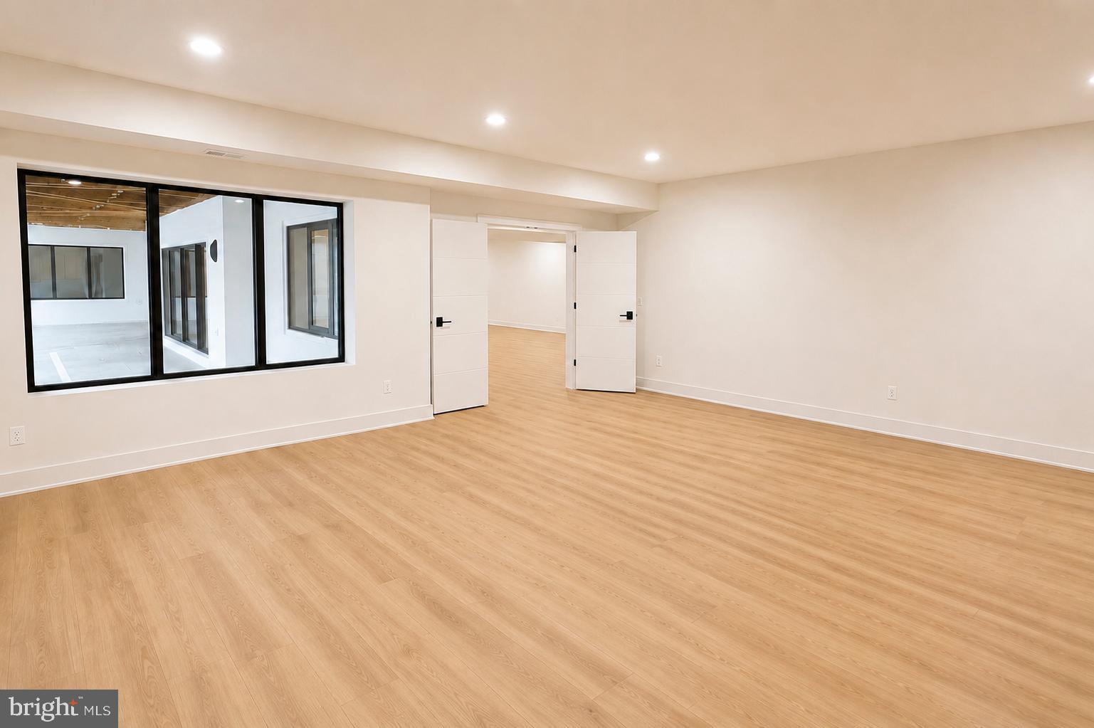 5947 Doyle Road Clifton, VA 20124 - Photo 61 of 69 a view of an empty room with wooden floor and a window