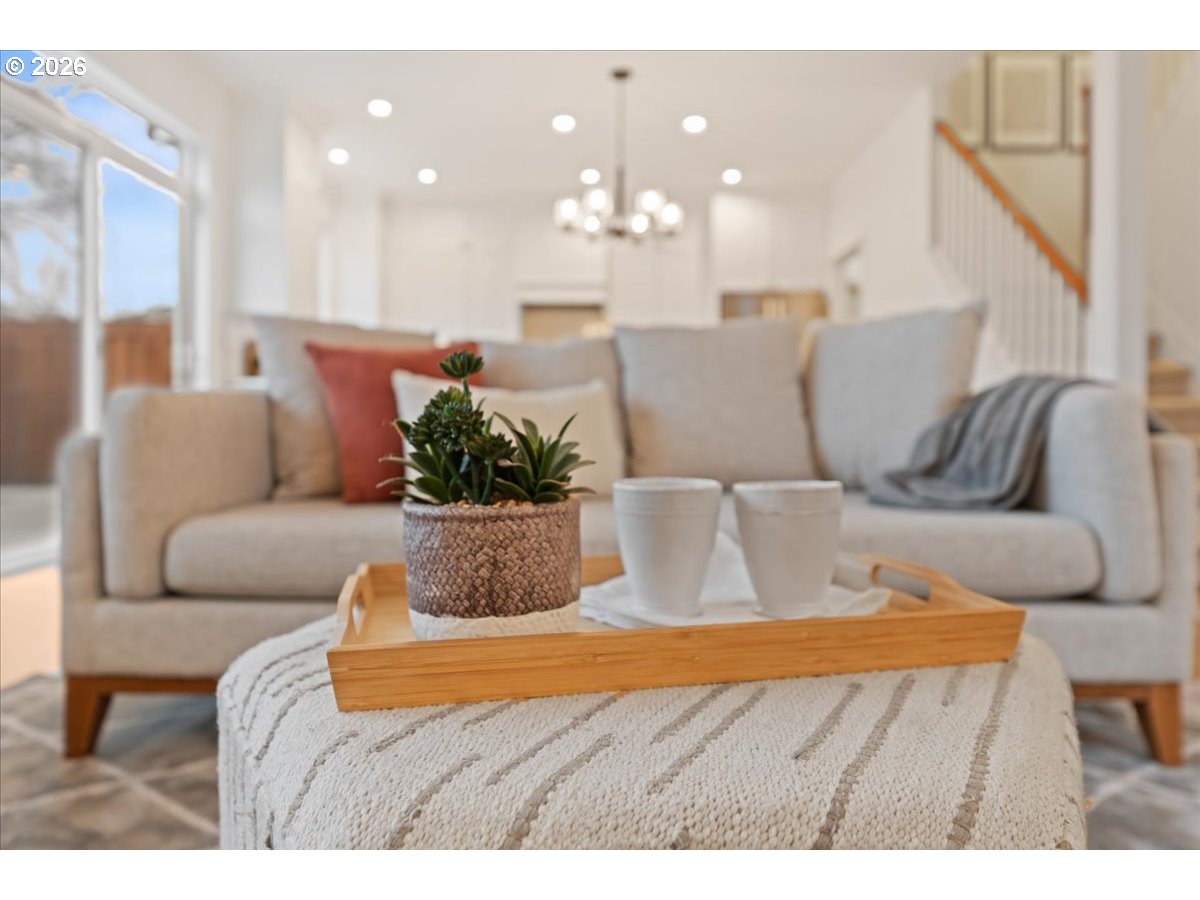 11595 Southwest Butte Lane Beaverton, OR 97008 - Photo 12 of 48 a living room with furniture and a chandelier
