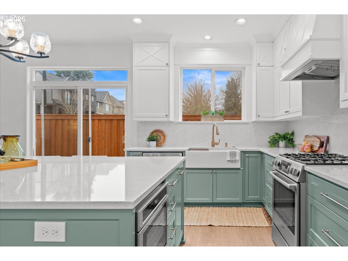 11595 Southwest Butte Lane Beaverton, OR 97008 - Photo 15 of 48 a kitchen with a sink a stove and cabinets