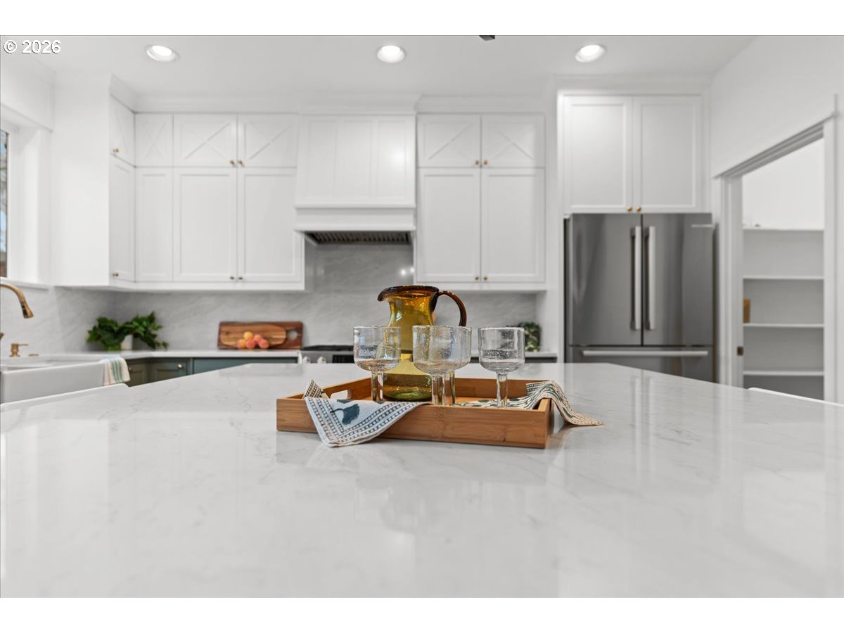 11595 Southwest Butte Lane Beaverton, OR 97008 - Photo 19 of 48 a kitchen with kitchen island granite countertop a refrigerator and a stove