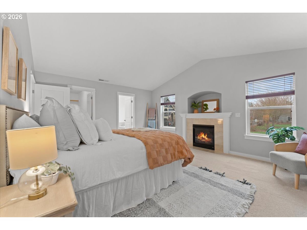 11595 Southwest Butte Lane Beaverton, OR 97008 - Photo 23 of 48 a bed room with a bed and a fireplace