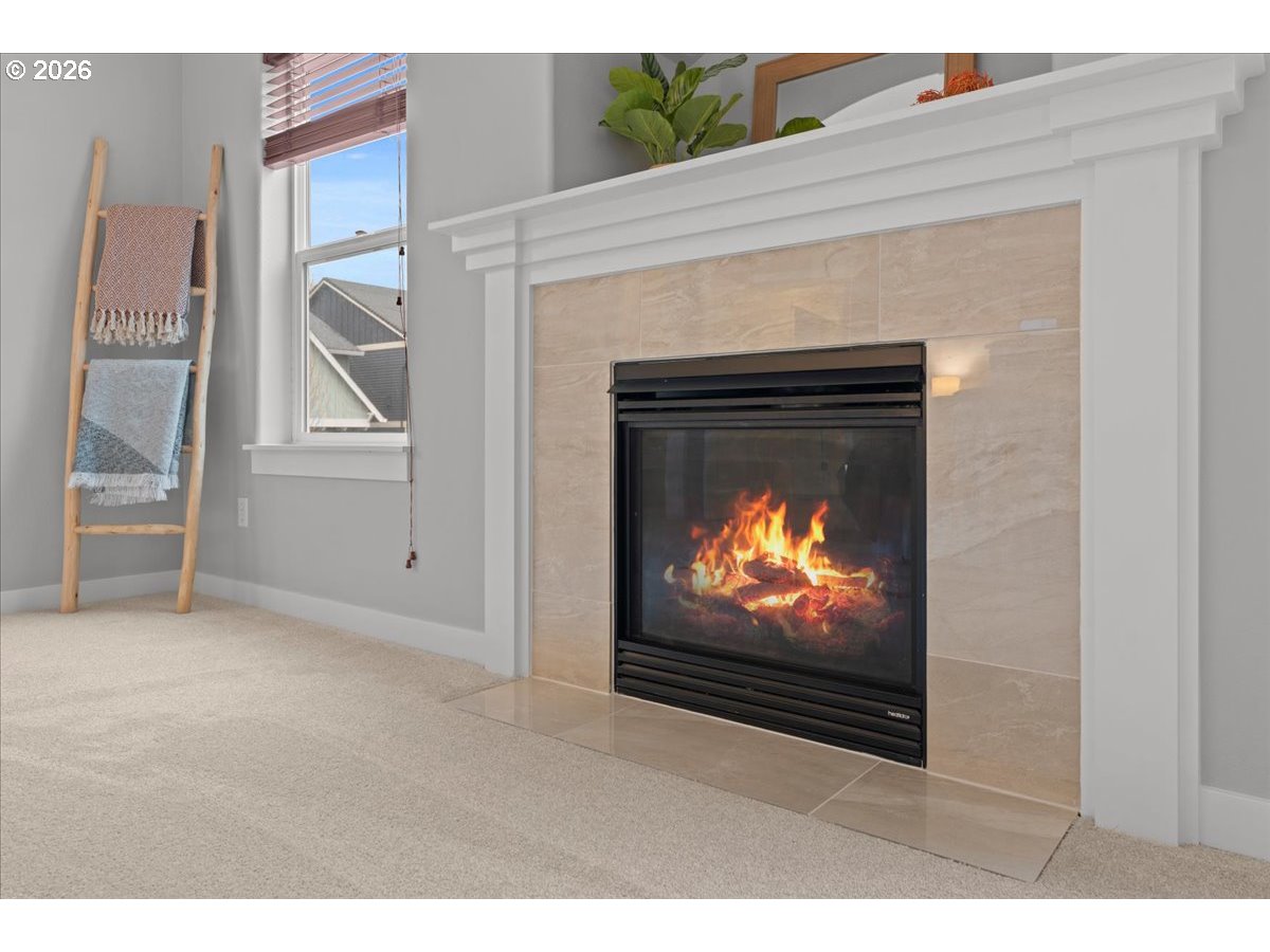 11595 Southwest Butte Lane Beaverton, OR 97008 - Photo 28 of 48 a living room with a fireplace and a television