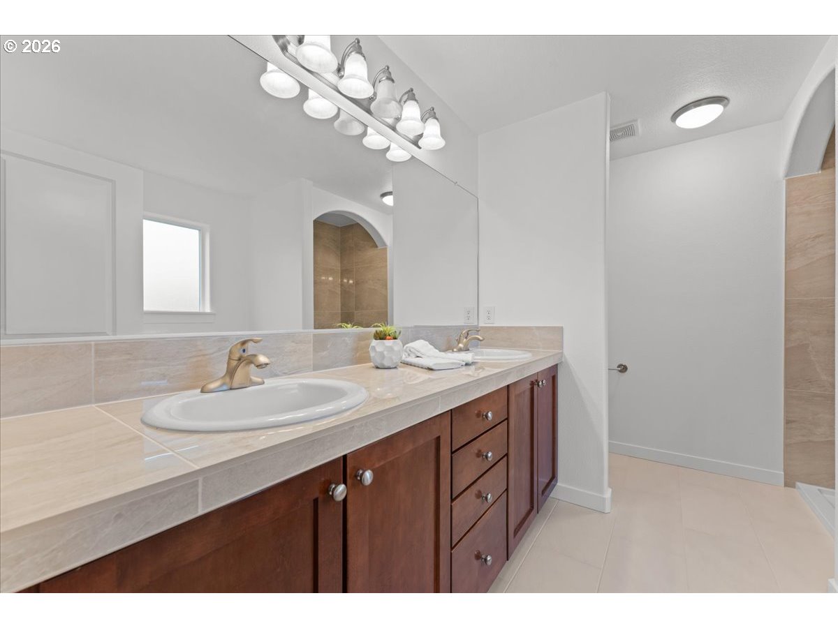 11595 Southwest Butte Lane Beaverton, OR 97008 - Photo 30 of 48 a bathroom with a sink vanity and a mirror